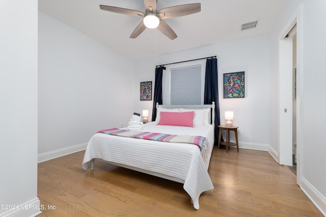 bedroom with light hardwood / wood-style floors and ceiling fan