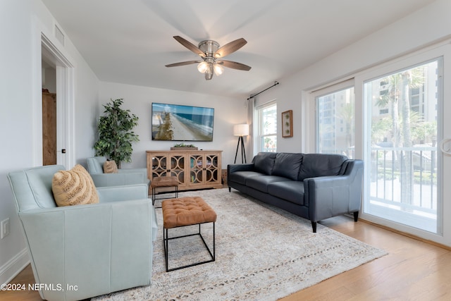 living room with wood-type flooring and ceiling fan