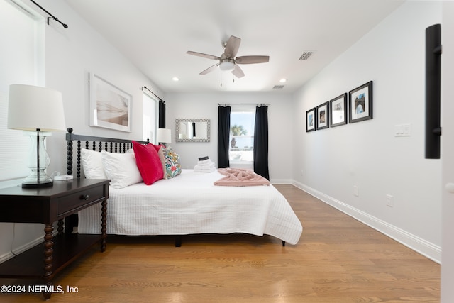 bedroom with wood-type flooring and ceiling fan