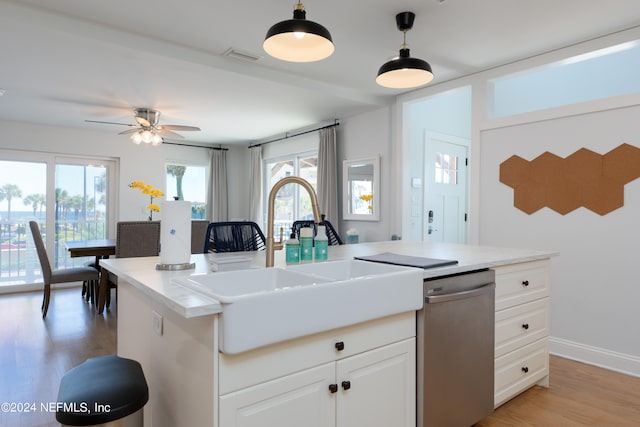 kitchen with a center island, pendant lighting, white cabinets, light hardwood / wood-style flooring, and dishwasher