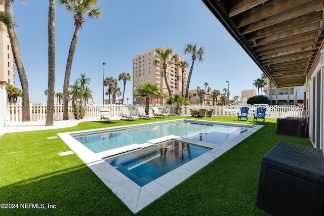 view of swimming pool with a lawn