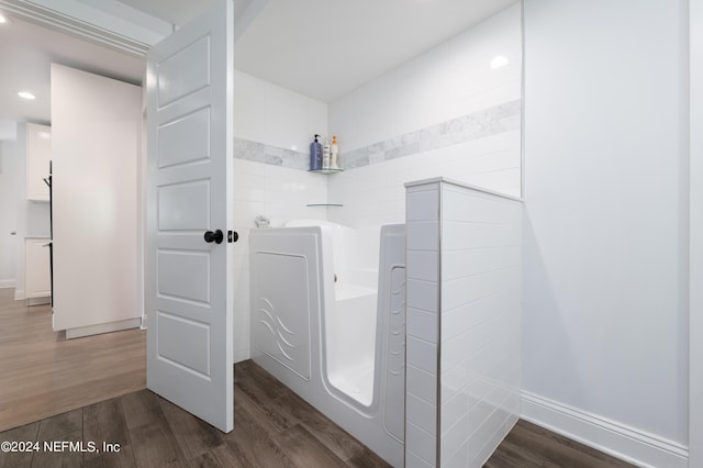 bathroom featuring wood-type flooring and separate shower and tub