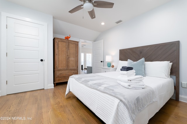 bedroom featuring wood-type flooring, ceiling fan, and vaulted ceiling