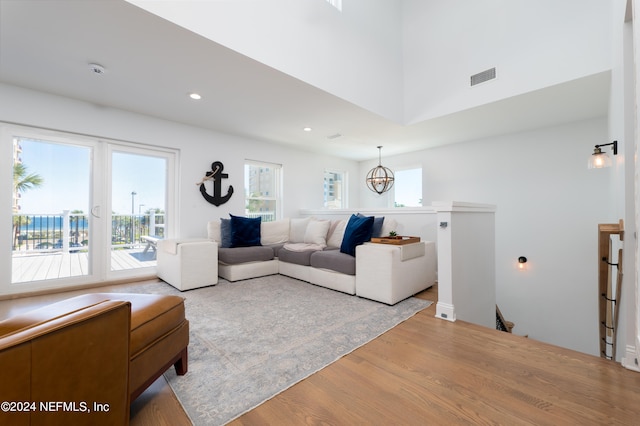 living room featuring hardwood / wood-style floors and an inviting chandelier