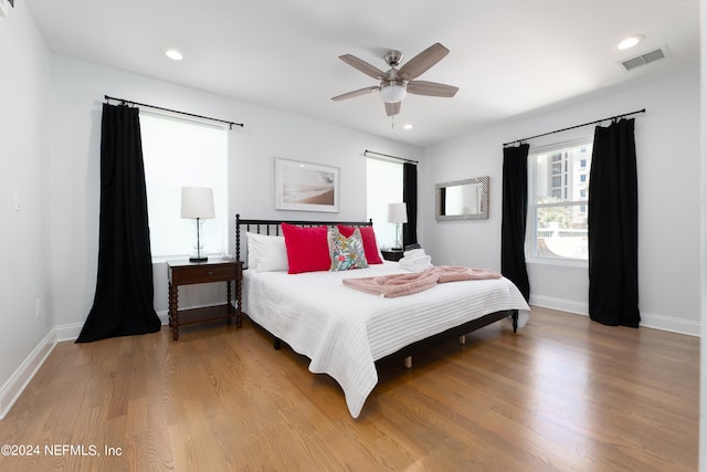 bedroom with ceiling fan and hardwood / wood-style flooring