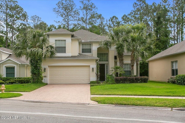 view of front of home with a garage and a front yard