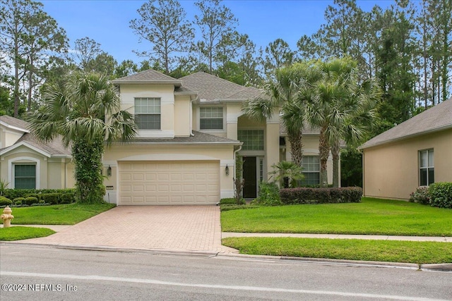 view of front of home with a garage and a front yard