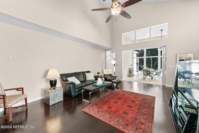 living room with high vaulted ceiling, ceiling fan, and dark wood-type flooring