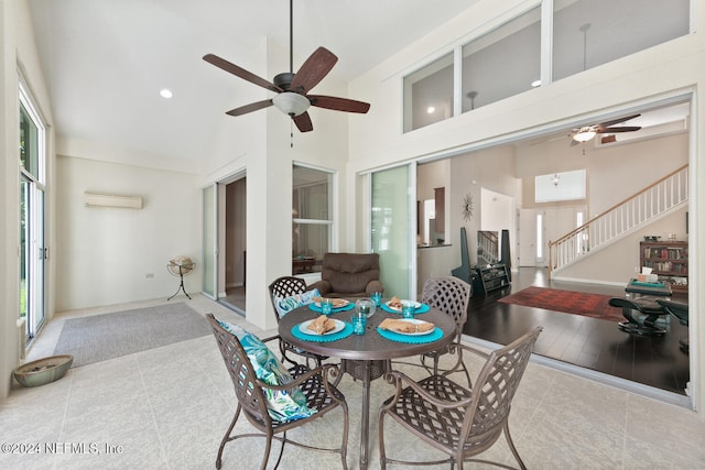 sunroom / solarium featuring a wall mounted AC, ceiling fan, and vaulted ceiling