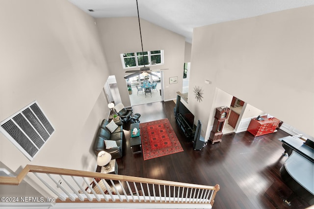 living room with ceiling fan, dark hardwood / wood-style flooring, and high vaulted ceiling