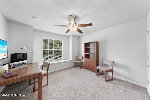 carpeted office with ceiling fan and a textured ceiling