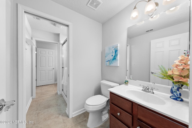 bathroom with vanity, tile patterned floors, toilet, a textured ceiling, and a chandelier