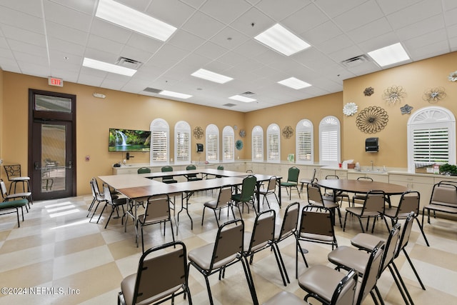 dining space with a drop ceiling