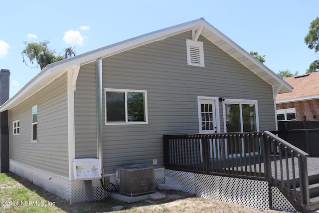 back of property featuring a deck and central AC unit