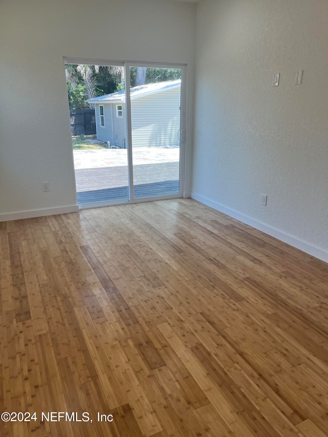 spare room with hardwood / wood-style floors