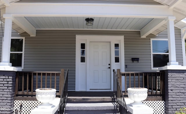 doorway to property featuring covered porch