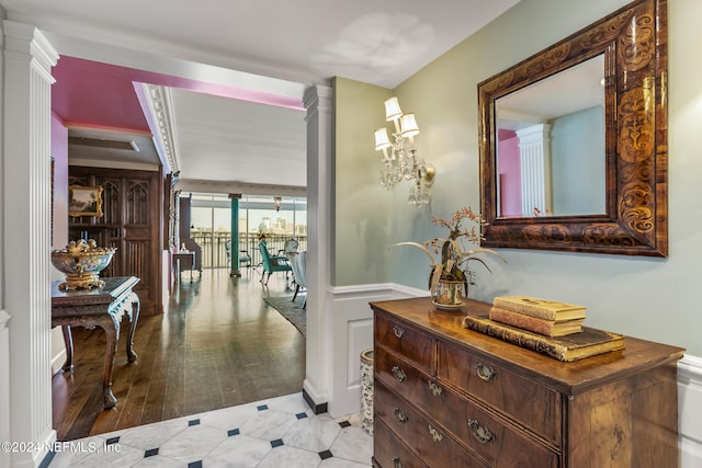 corridor featuring decorative columns and light hardwood / wood-style floors