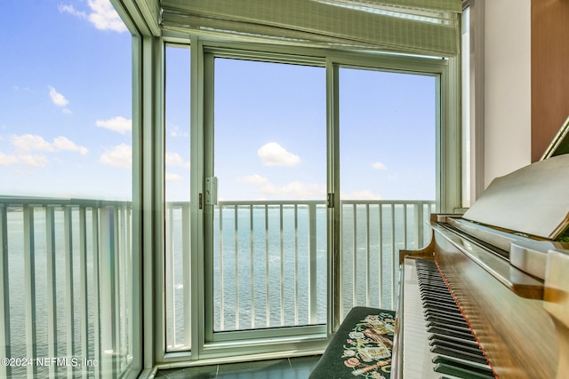 unfurnished sunroom with a water view