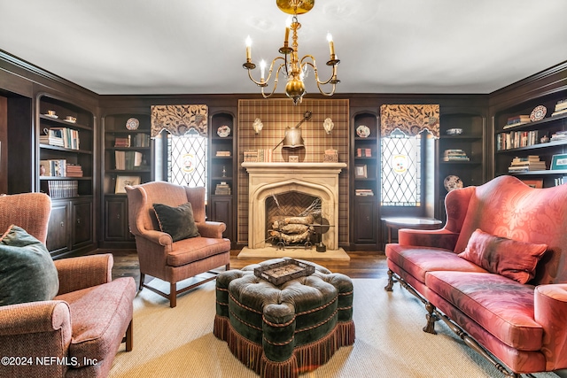 living room featuring a fireplace, built in features, and a notable chandelier