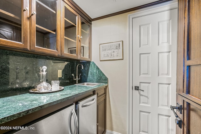 bar featuring decorative backsplash, crown molding, sink, and dark stone counters