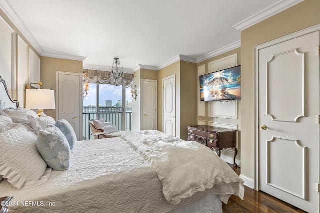 bedroom with access to exterior, an inviting chandelier, dark hardwood / wood-style floors, and ornamental molding