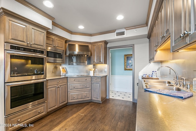 kitchen with ornamental molding, stainless steel appliances, dark wood-type flooring, sink, and wall chimney range hood