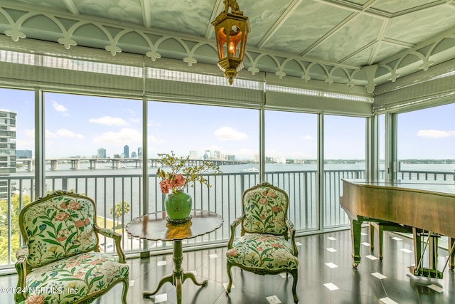 sunroom / solarium featuring a water view and a wealth of natural light