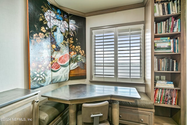 office space with built in desk and crown molding