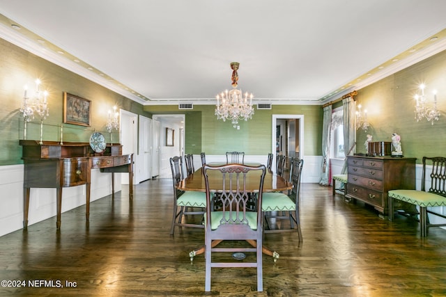 dining space with dark hardwood / wood-style flooring, crown molding, and an inviting chandelier