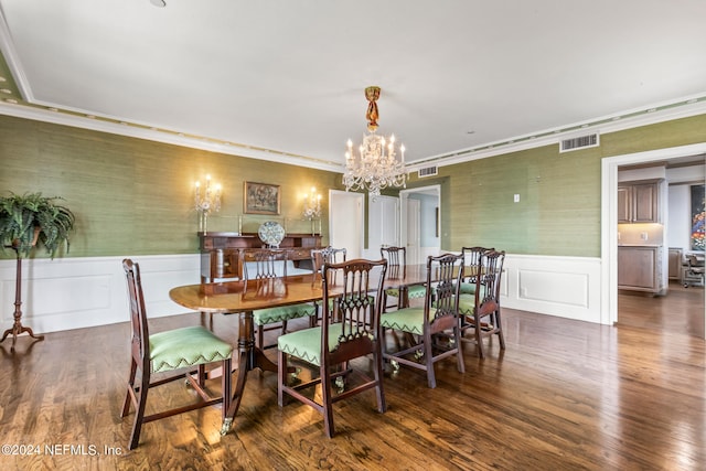 dining space with ornamental molding, dark hardwood / wood-style floors, and a notable chandelier