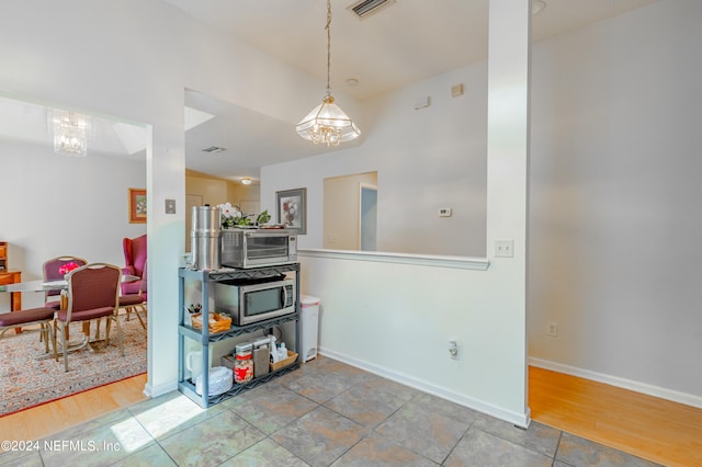 interior space with hardwood / wood-style flooring and a chandelier