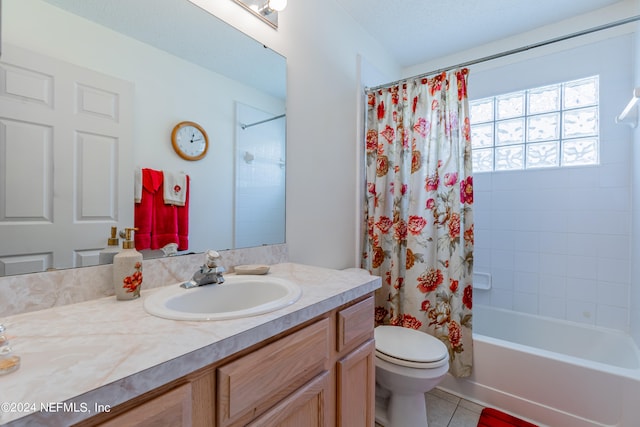 full bathroom with vanity with extensive cabinet space, shower / tub combo, a textured ceiling, tile floors, and toilet