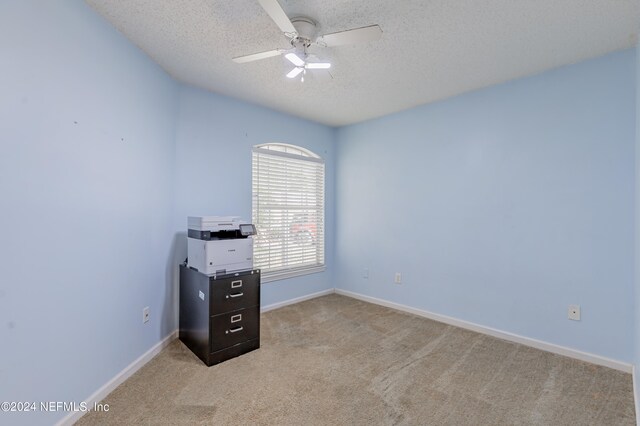 interior space with ceiling fan and a textured ceiling