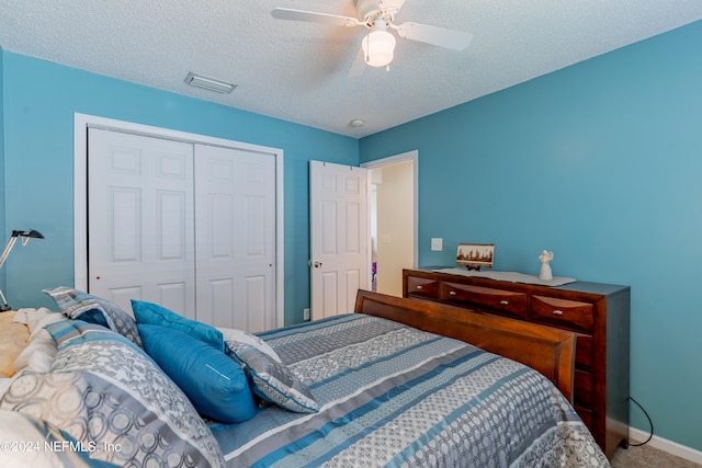 bedroom with a closet, ceiling fan, and a textured ceiling