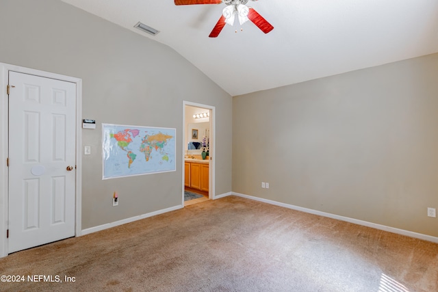 empty room featuring carpet floors, ceiling fan, and vaulted ceiling