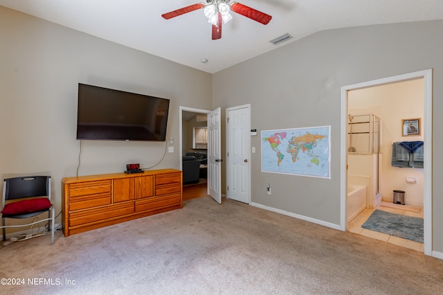 bedroom featuring carpet, ceiling fan, ensuite bath, and lofted ceiling