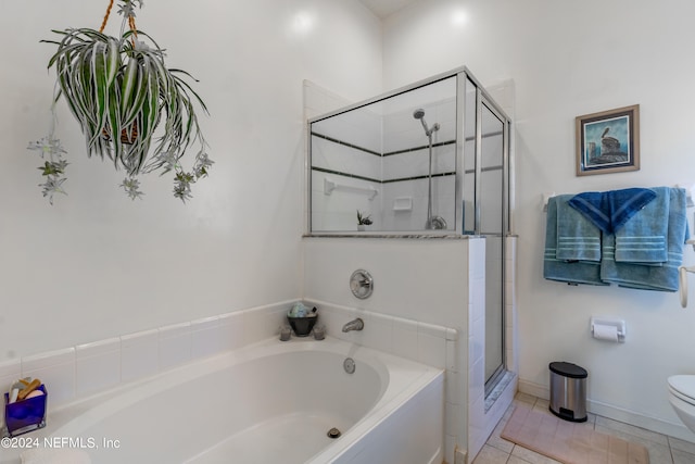 bathroom featuring shower with separate bathtub, toilet, and tile floors