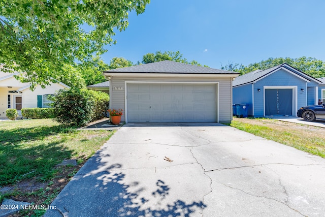 garage featuring a lawn