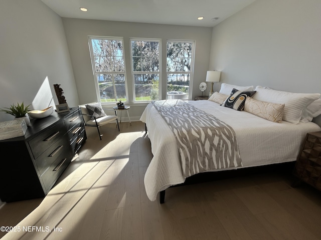 bedroom with wood-type flooring and recessed lighting