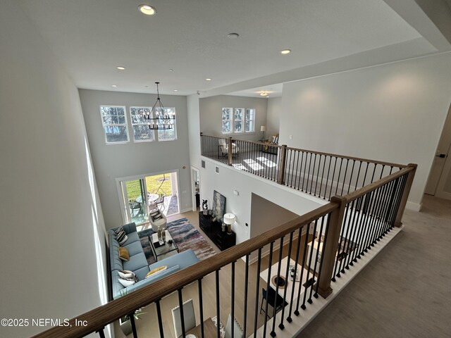 staircase with carpet, a high ceiling, a chandelier, and recessed lighting