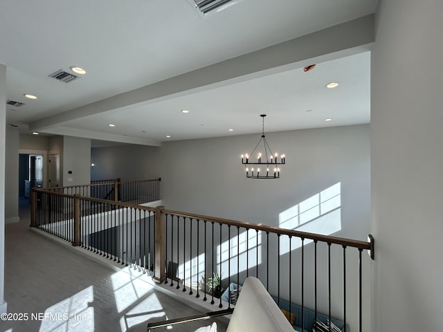 hallway featuring recessed lighting, visible vents, an upstairs landing, and an inviting chandelier