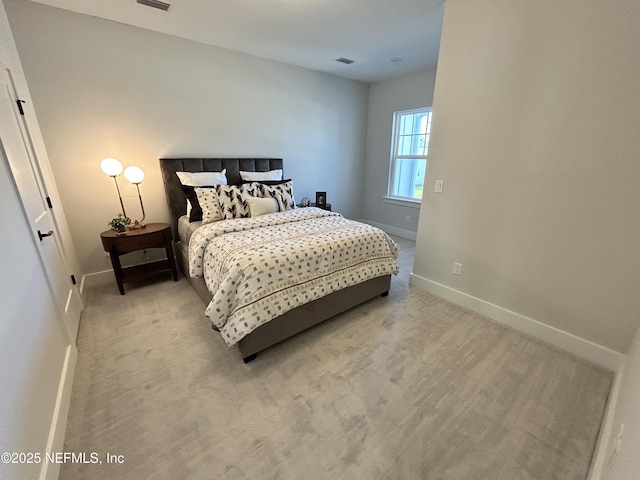 carpeted bedroom featuring visible vents and baseboards