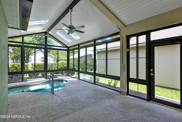 view of pool with a skylight and ceiling fan