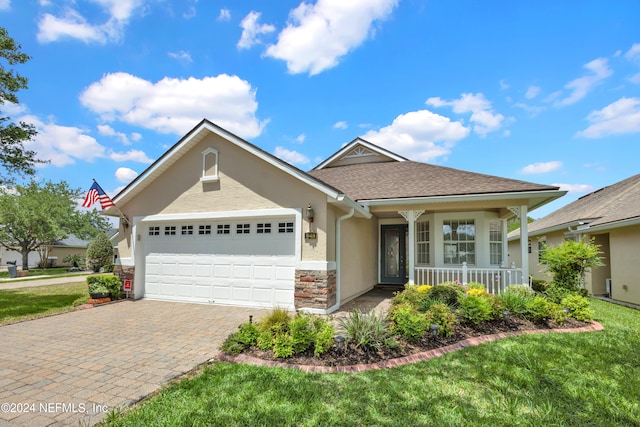 view of front of house with a front lawn, a porch, and a garage