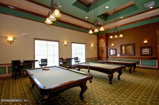 recreation room featuring dark colored carpet, crown molding, and a tray ceiling