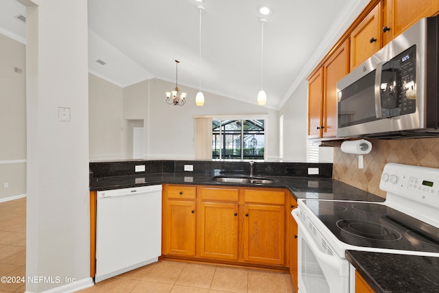 kitchen with white appliances, hanging light fixtures, lofted ceiling, and sink