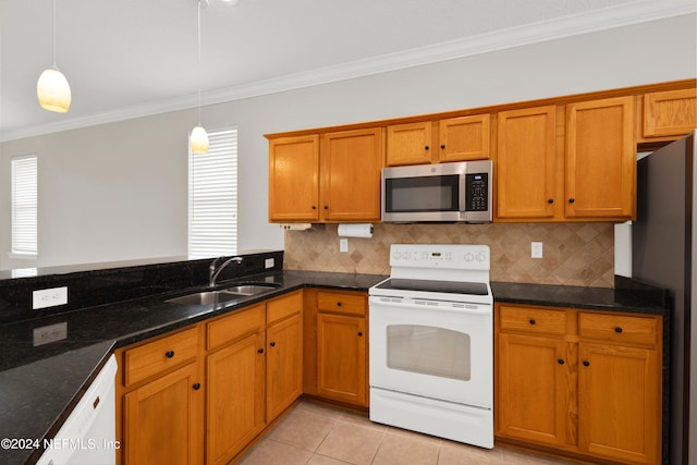 kitchen with pendant lighting, plenty of natural light, sink, and appliances with stainless steel finishes