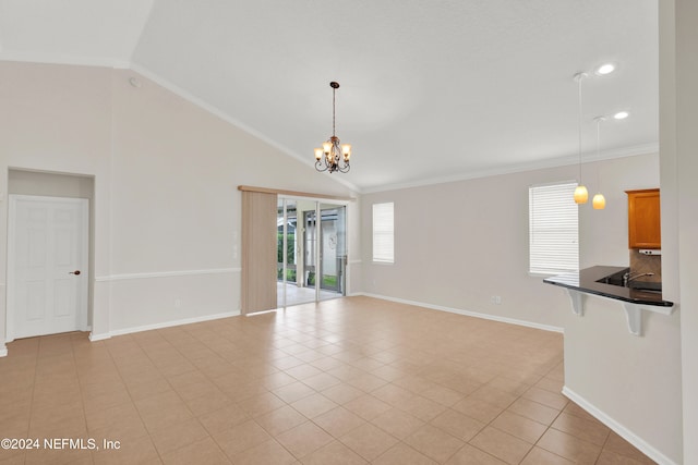 empty room with light tile patterned floors, high vaulted ceiling, crown molding, and a notable chandelier