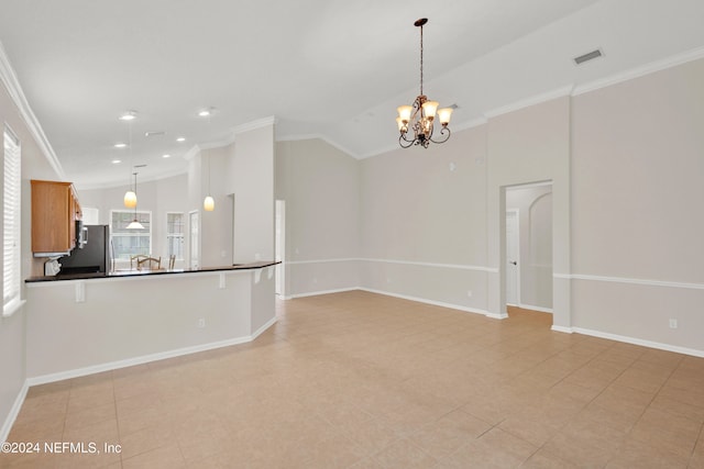 kitchen with stainless steel fridge, crown molding, a chandelier, vaulted ceiling, and decorative light fixtures