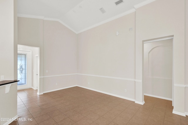 tiled empty room featuring high vaulted ceiling and ornamental molding